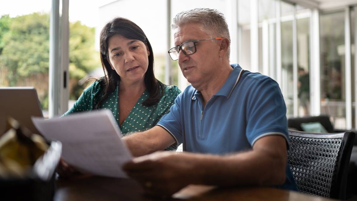 Two older adults comparing the prices of healthcare treatments. Next Avenue, value based care, medicare