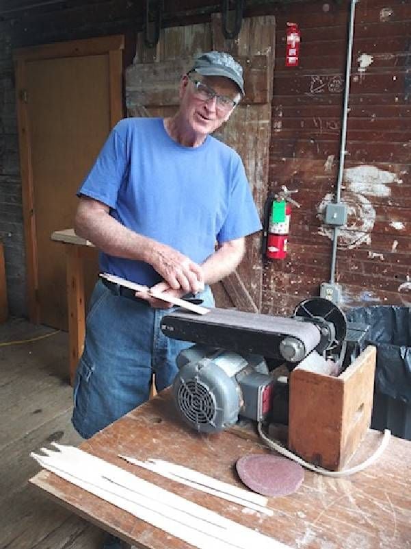 A man sanding wooden strips. Next Avenue, crafts older adults, craft schools