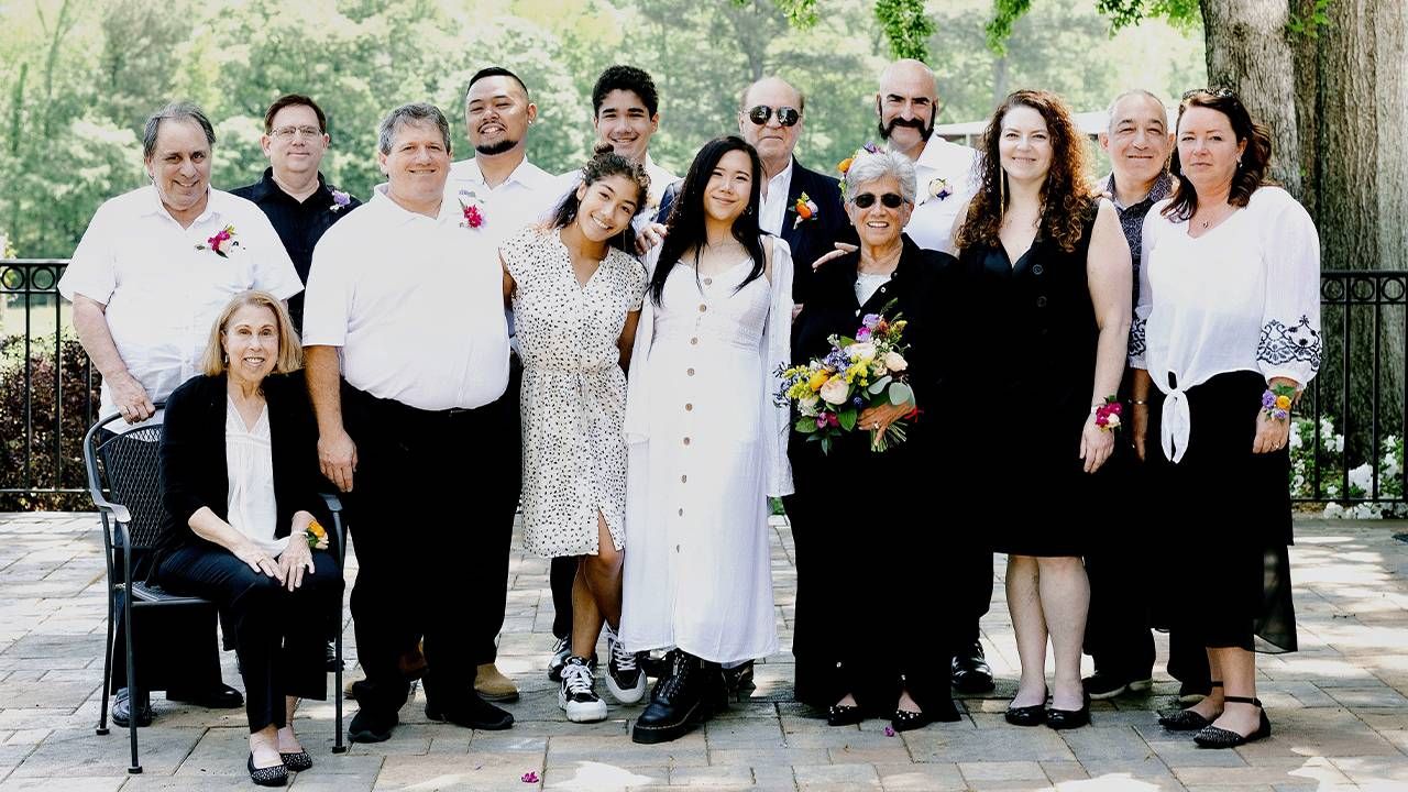 A newly married couple smiling with their family. Next Avenue, Marrying married later in life