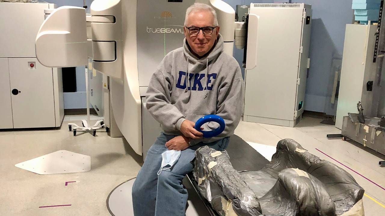 A man sitting in a medical examination room. Next Avenue, hot flashes in men prostate cancer