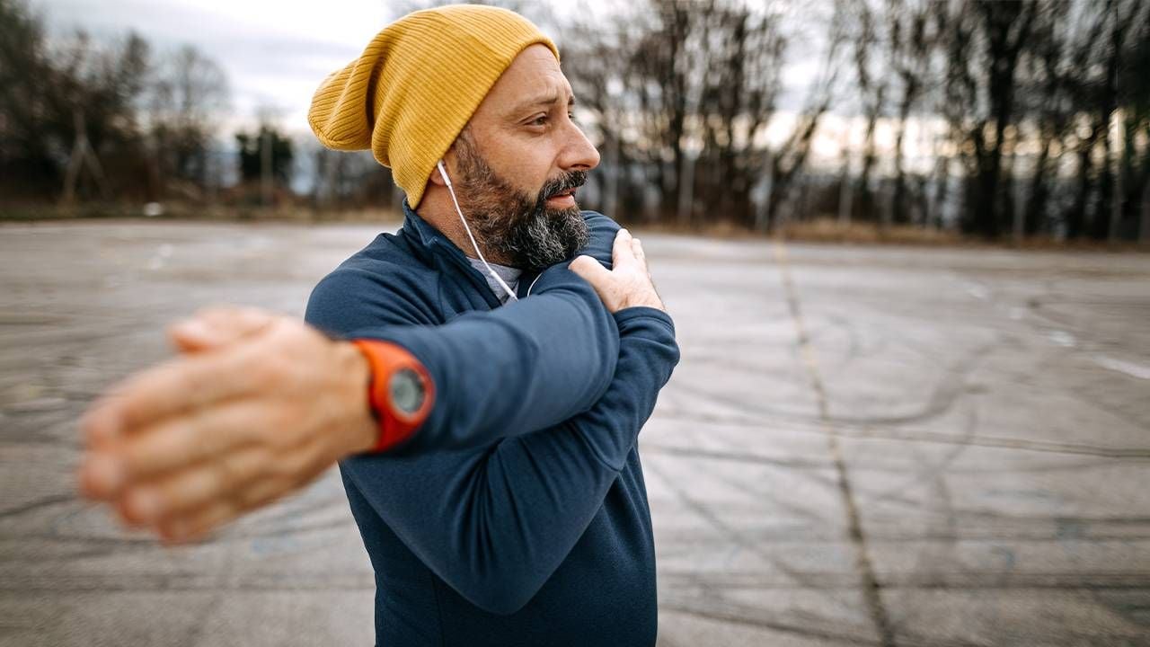 A man over 55 stretching outside. Next Avenue, Men's guide to health