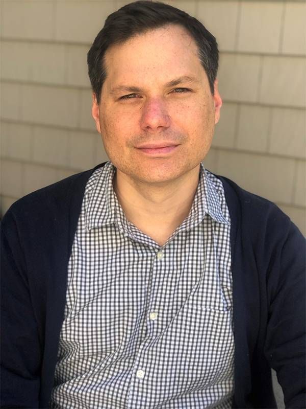 A headshot of Michael Ian Black sitting outside. Next Avenue, A Better Man