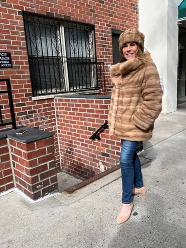 A woman wearing a short fur coat. Next Avenue, what to do with old fur coats