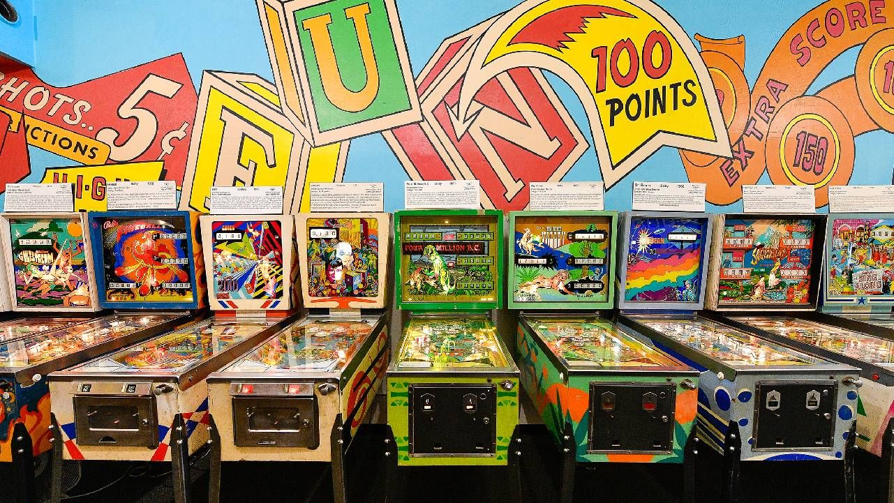 Multiple colorful vintage pinball machines. Next Avenue, quirky collections, museums