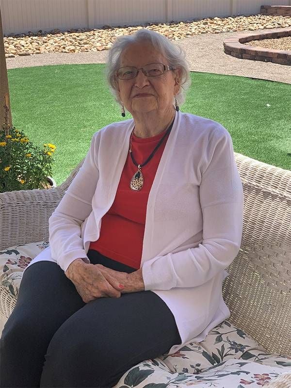 An older woman sitting on a patio bench. Next Avenue, vetassist