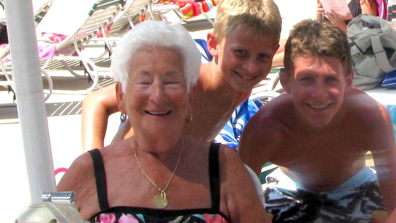 An older woman smiling next to two younger children.  Next Avenue, friendship between ages, friendship between generations