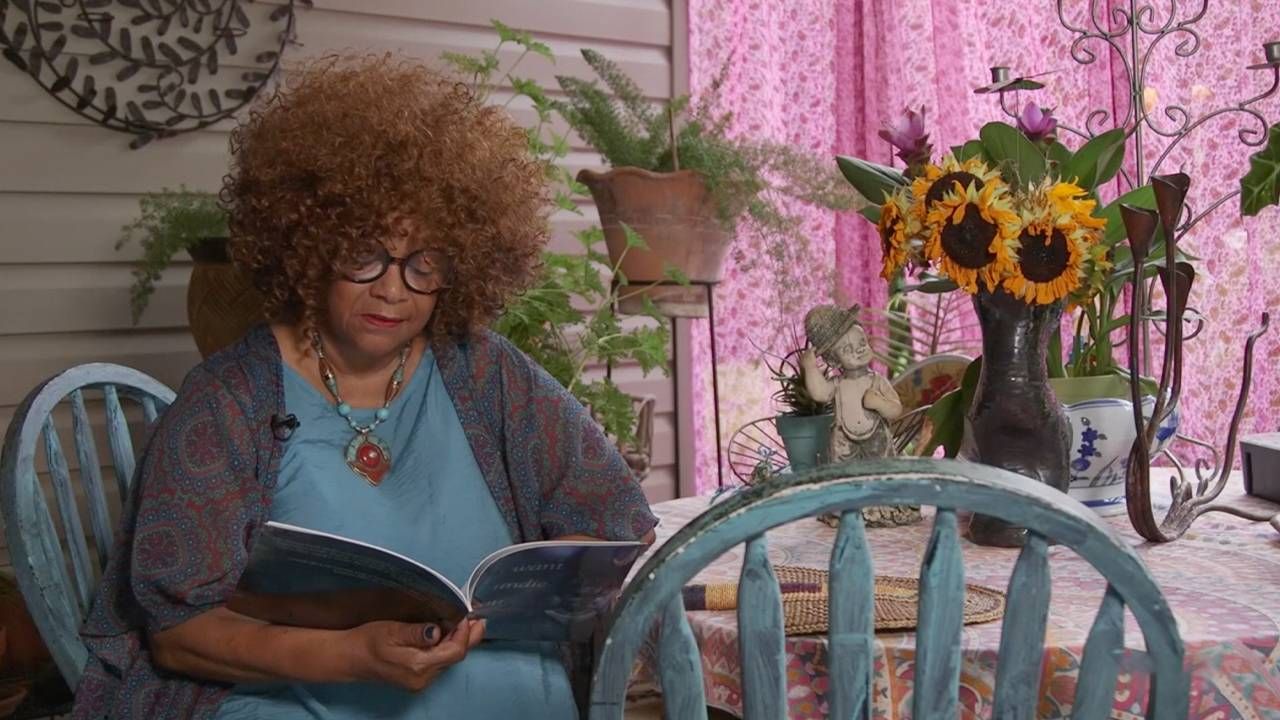 A woman reading a book on her porch. Next Avenue, Jaki Shelton Green