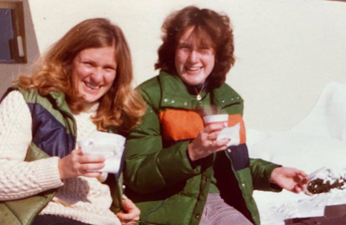 Two women sitting outside drinking coffee. Next Avenue, Life before Title IX, impact of Title IX