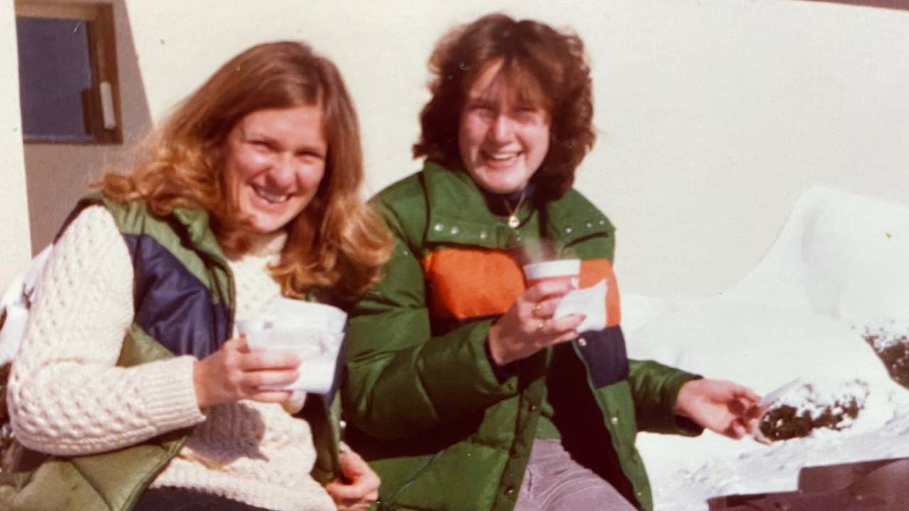 Two women sitting outside drinking coffee. Next Avenue, Life before Title IX, impact of Title IX