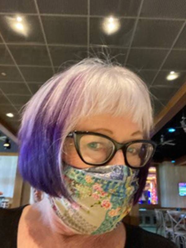 A woman with gray and purple hair wearing a face mask. Next Avenue, abortions before roe vs. wade