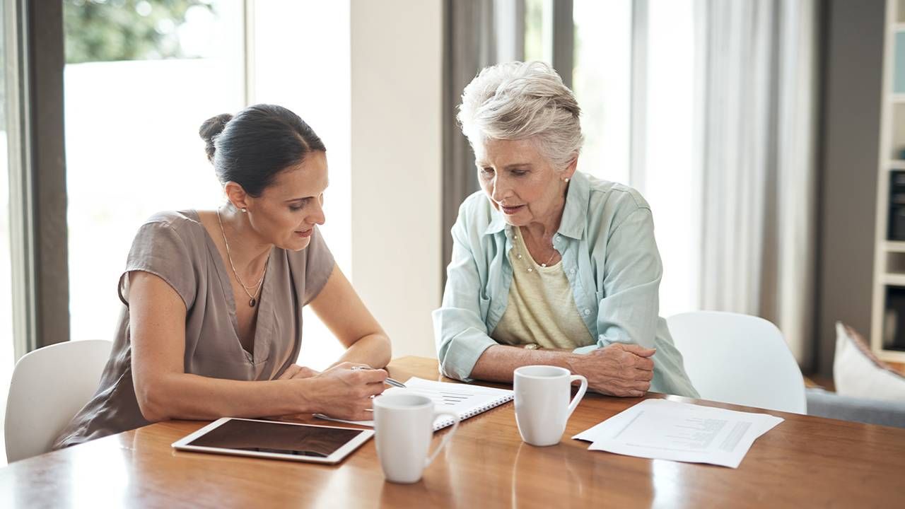 An older adult calculating her retirement savings. Next Avenue