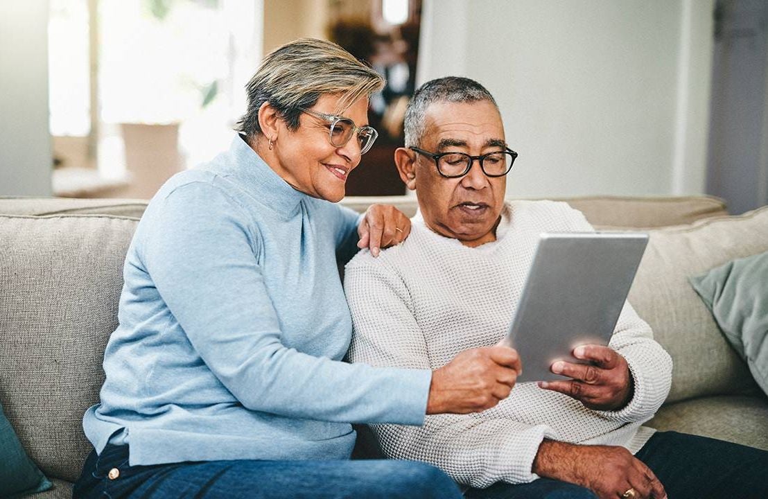 Two older adults using an app on an ipad. Next Avenue, smartphone apps for caregivers