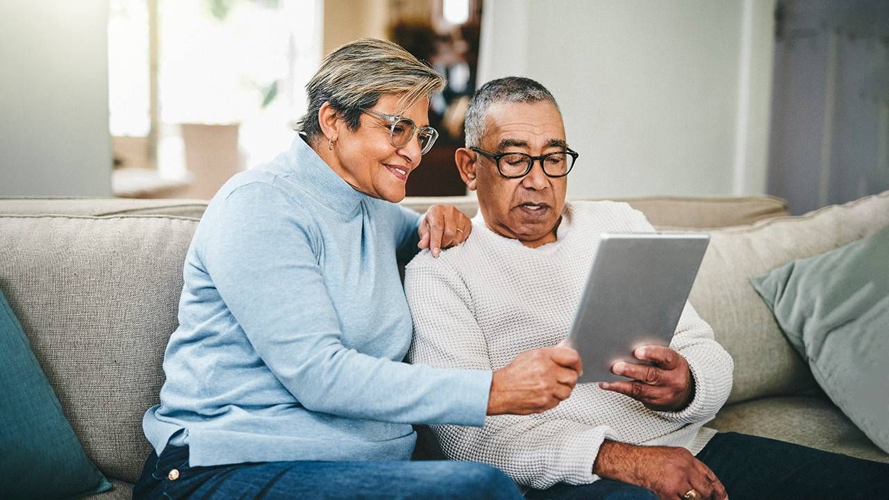 Two older adults using an app on an ipad. Next Avenue, smartphone apps for caregivers