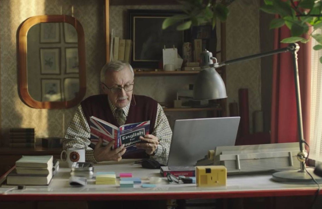 A man reading a book at his desk. Next Avenue, Pro-aging ads,