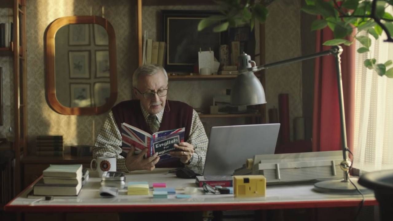 A man reading a book at his desk. Next Avenue, Pro-aging ads,