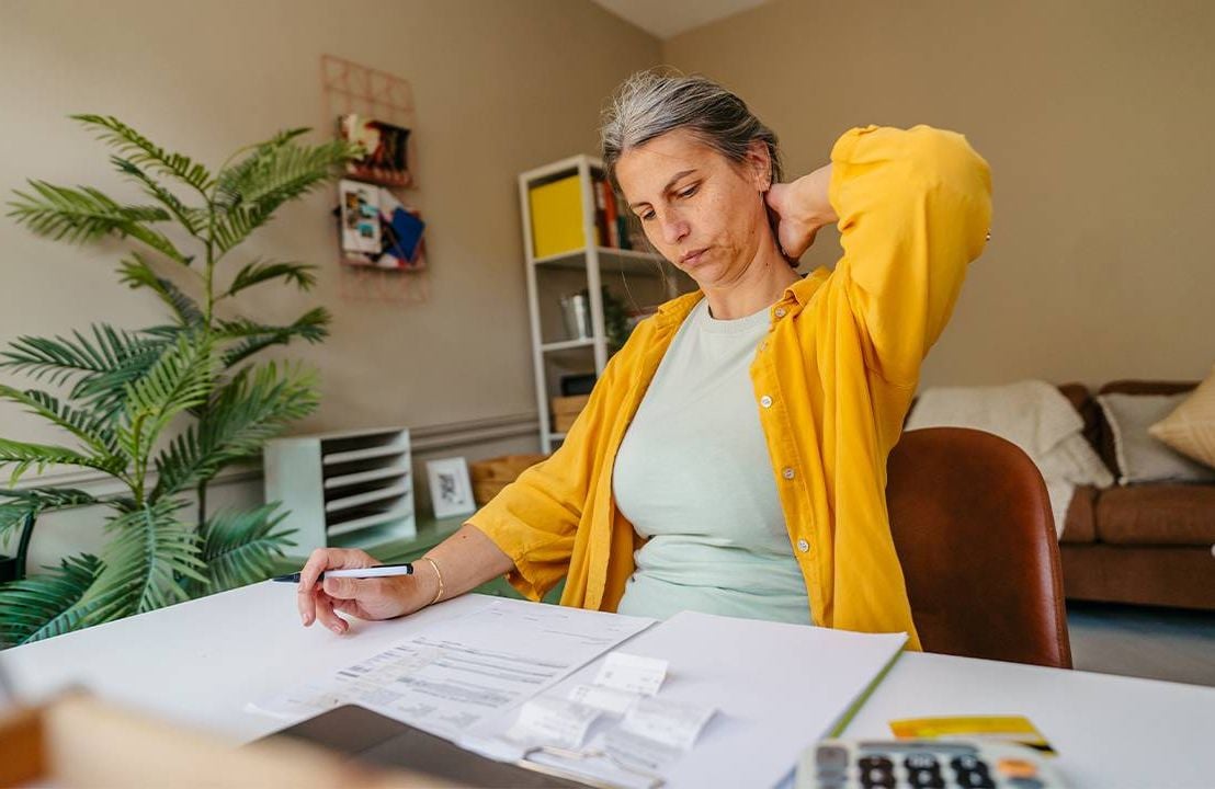 A woman calculating her retirement savings and investment. Next Avenue