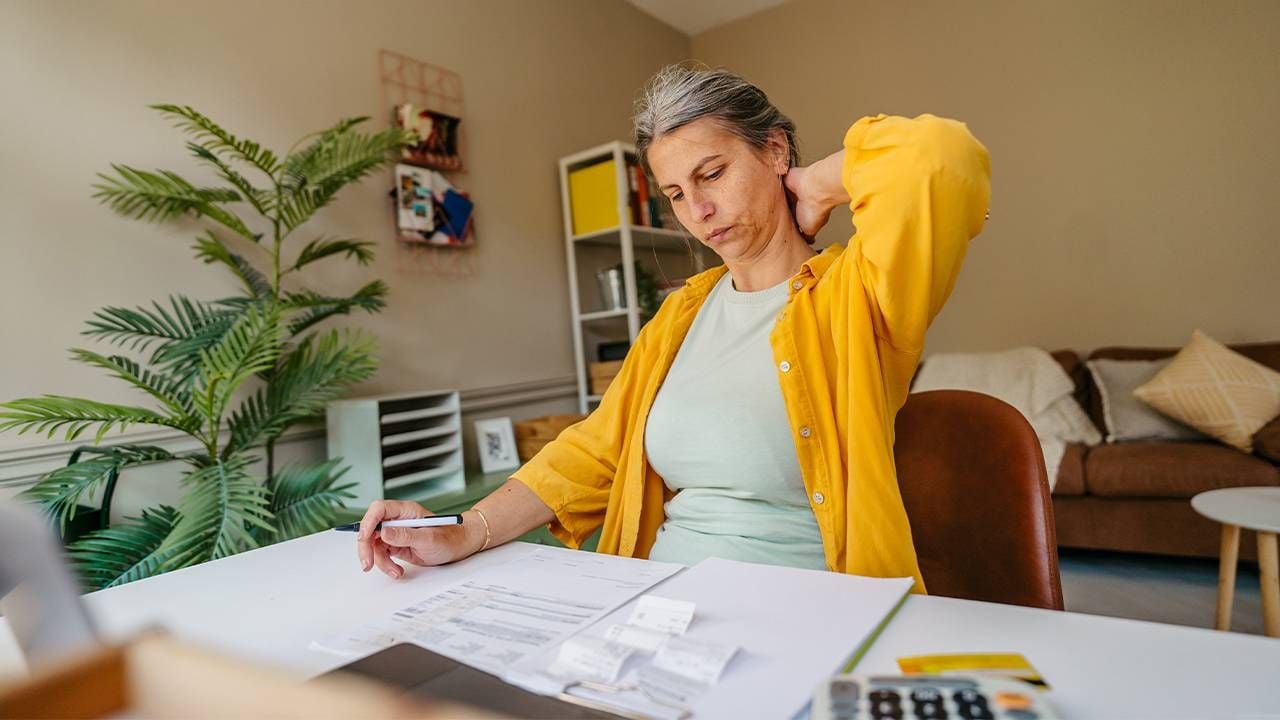 A woman calculating her retirement savings and investment. Next Avenue
