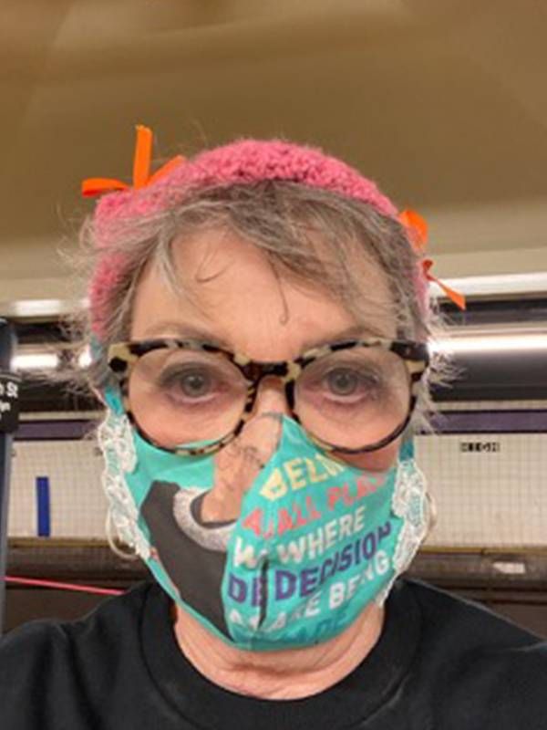 A woman wearing a face mask and pink headband. Next Avenue, abortions before roe vs. wade