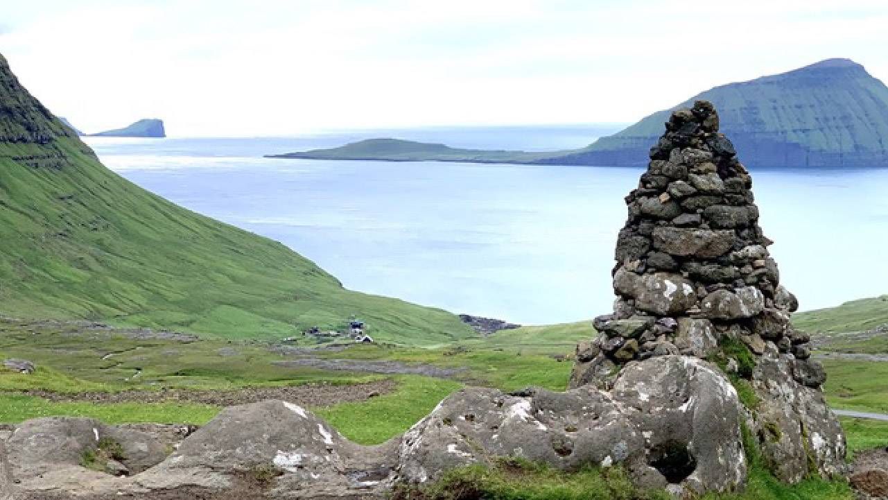 Grassy hillsides coming up to the edge of the ocean. Next Avenue, Faroe Islands history vikings