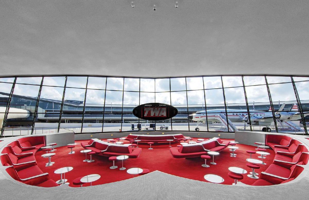 A 60s-style lounge with all red upholstery and carpeting. Next Avenue, JFK Airport, TWA Hotel