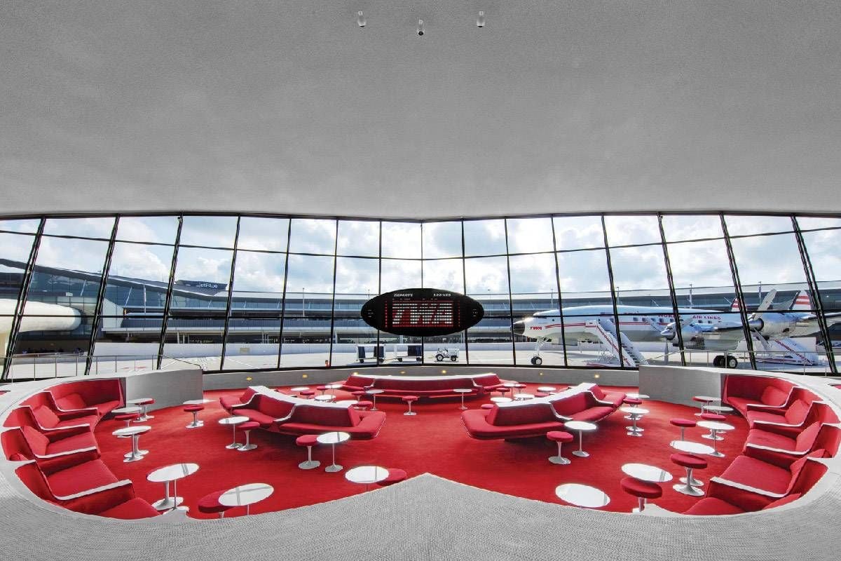 A 60s-style lounge with all red upholstery and carpeting. Next Avenue, JFK Airport, TWA Hotel