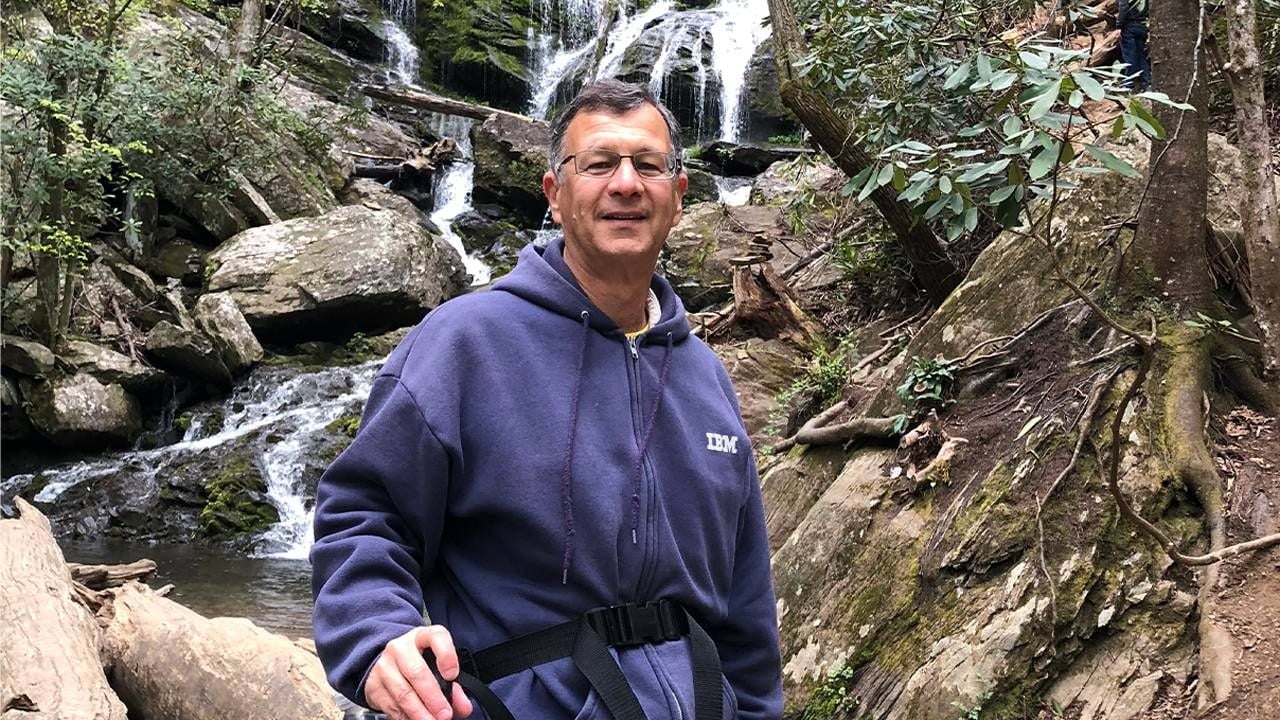 A man standing in front of a waterfall. Next Avenue, What is my true age