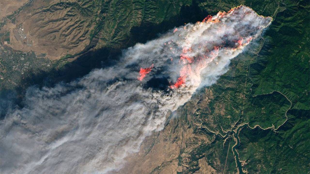 A plume of smoke with bright orange flames as seen from space. Next Avenue, wildfires, camp fire, paradise