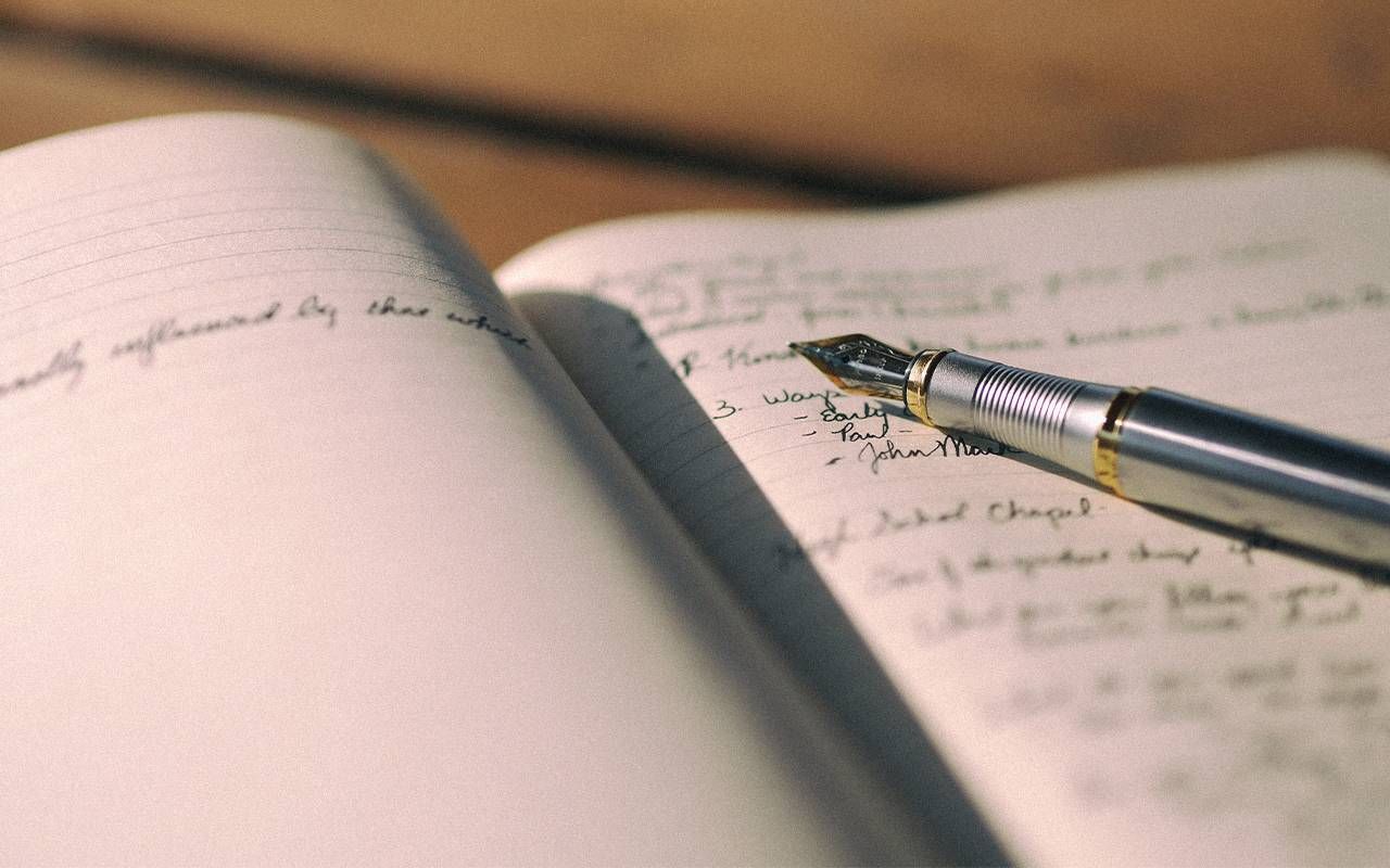 A closeup shot of a pen on a journal. Next Avenue