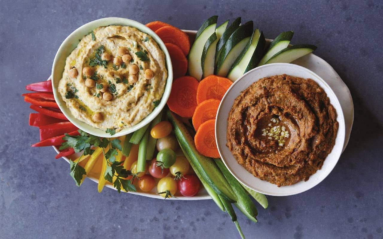 A plate with fresh vegetables and two types of hummus dip. Next Avenue, looking good at 50, Mareya Ibrahim