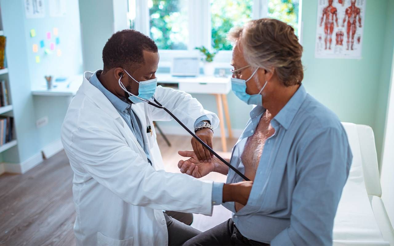 A doctor checking a patient's blood pressure. Next Avenue, Difference between stroke, heart attack, cardiac arrest, heart failure