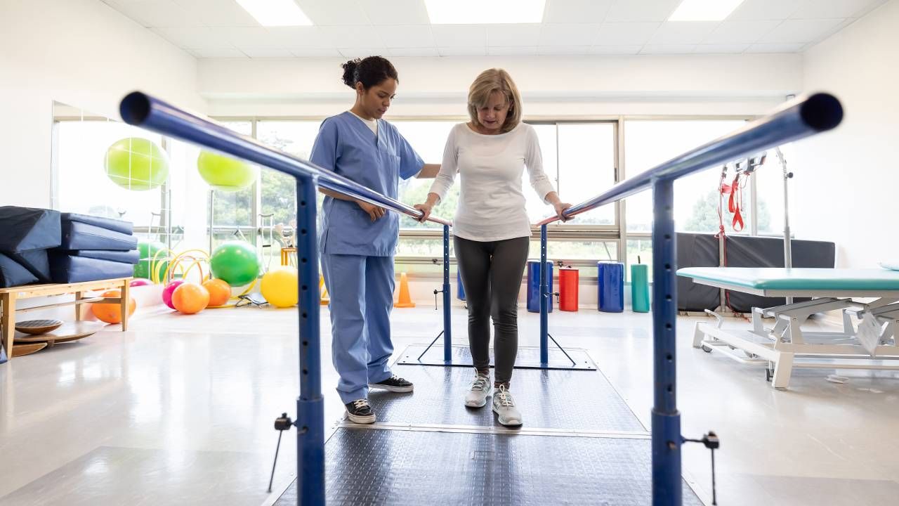 A woman walking during a physical therapy appointment. Next Avenue, healing from surgery, injury, patience