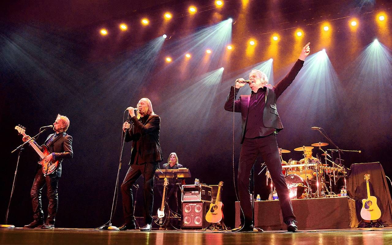 Three people on stage during a concert. Next Avenue, Three Dog Night, Danny Hutton