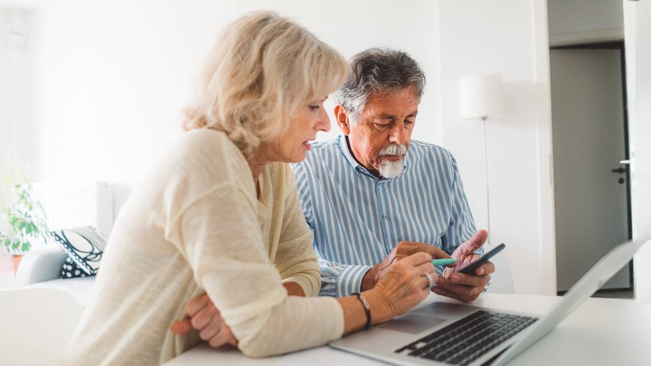 Two retired adults looking at their retirement savings plan. Next Avenue, outliving retirement savings