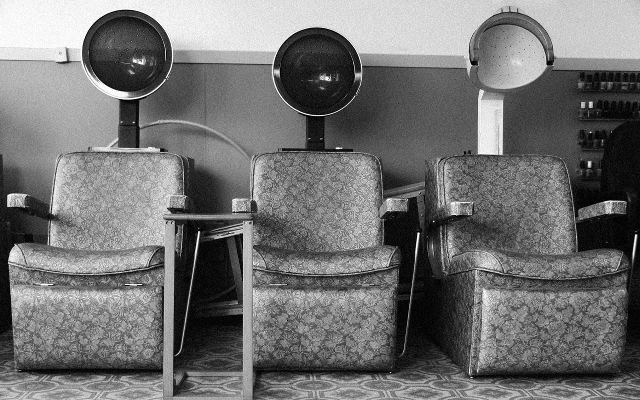 A row of retro hair dryer chairs. Next Avenue