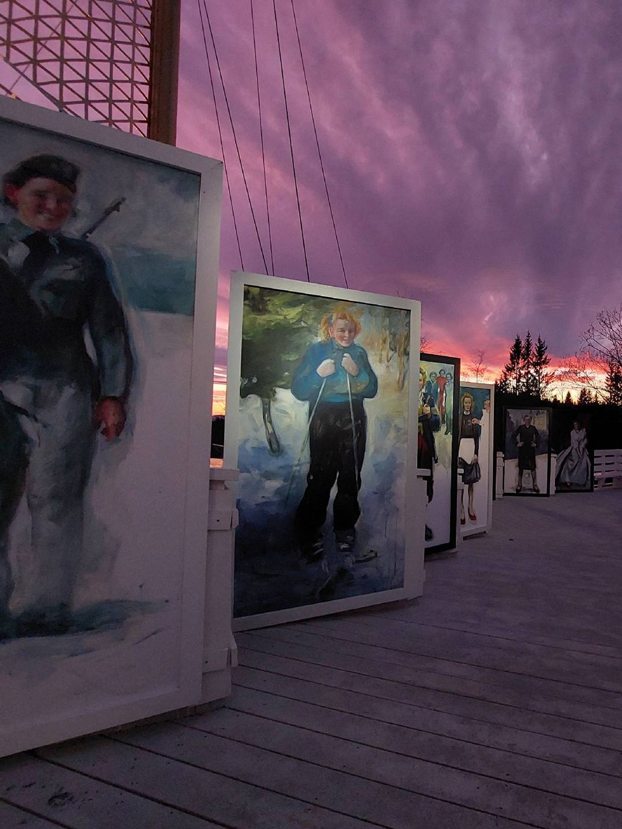 A boardwalk filled with painted portraits. Next Avenue, Rose Castle, Norway