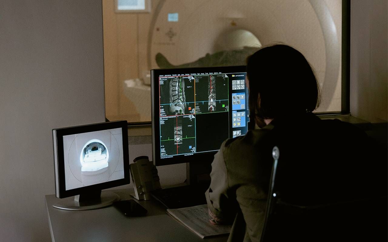 A radiologist looking at a person's MRI scan. Next Avenue, new MS diagnosis