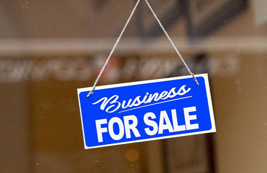A "business for sale" sign in the door of a business. Next Avenue, selling a business