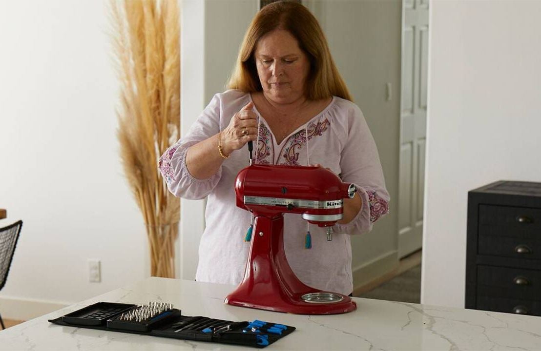 A person fixing their mixer at home. Next Avenue,