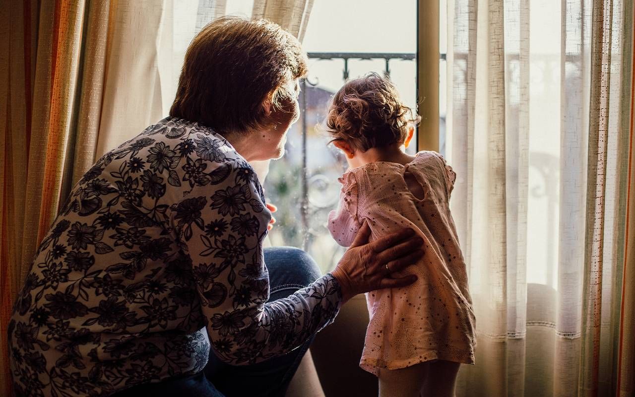 A grandmother and her grandchild looking out of the window. Next Avenue, Blended family grandparents