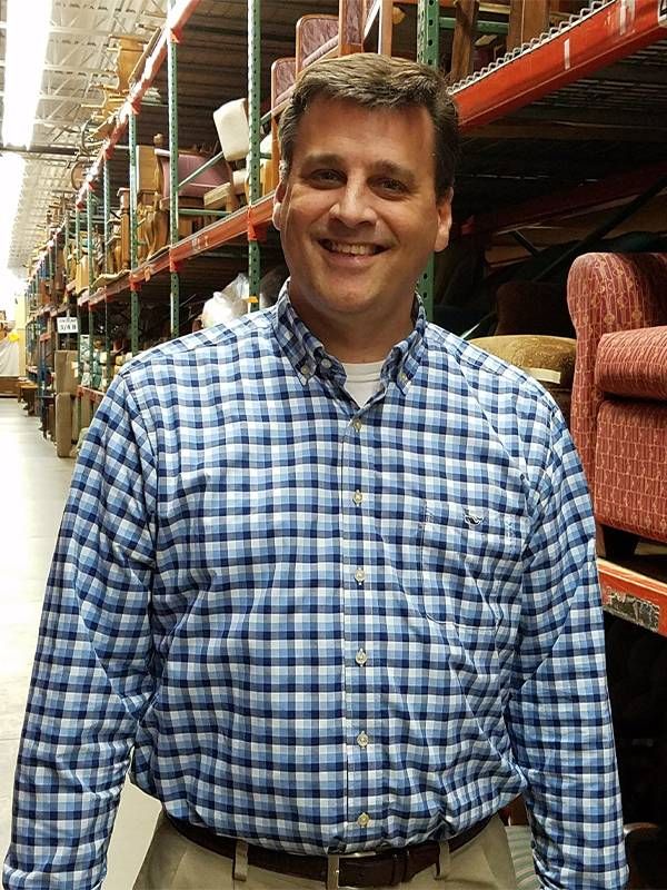 A man standing in a large furniture warehouse. Next Avenue, Next Avenue, how to prevent and end homelessness among older adults