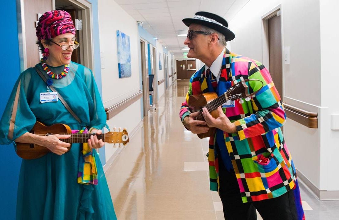 Colorfully dressed people holding musical instruments. Next Avenue, can music help people with Alzheimer's