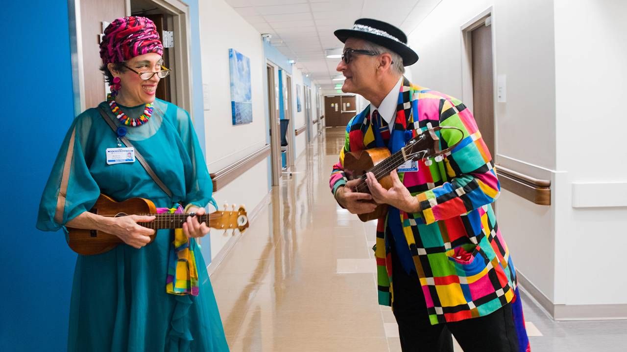 Colorfully dressed people holding musical instruments. Next Avenue, can music help people with Alzheimer's