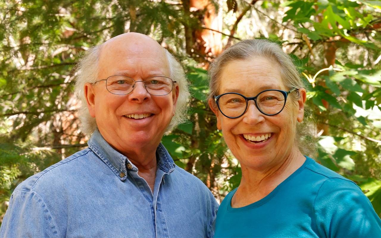 An older couple smiling outside. Next Avenue, forest restoration, forestry