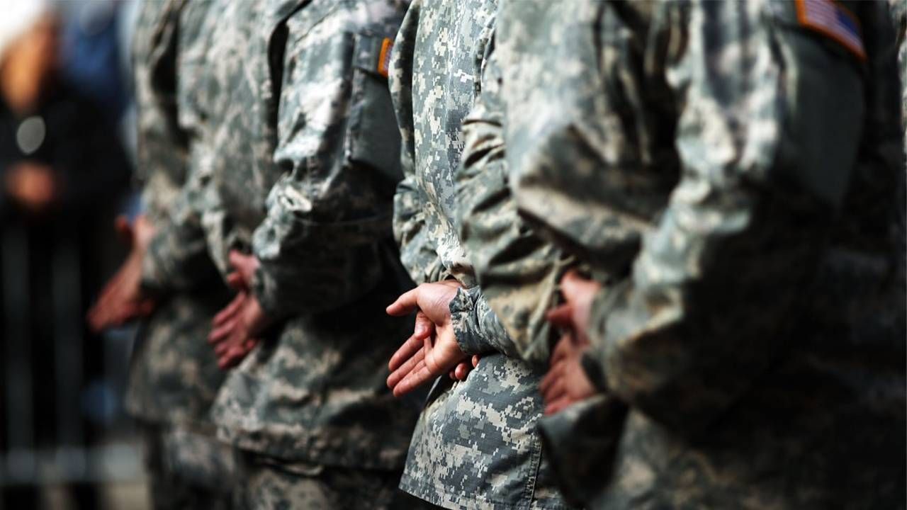 Several U.S. soldiers standing at ease in a line. Next Avenue, veterans suicide