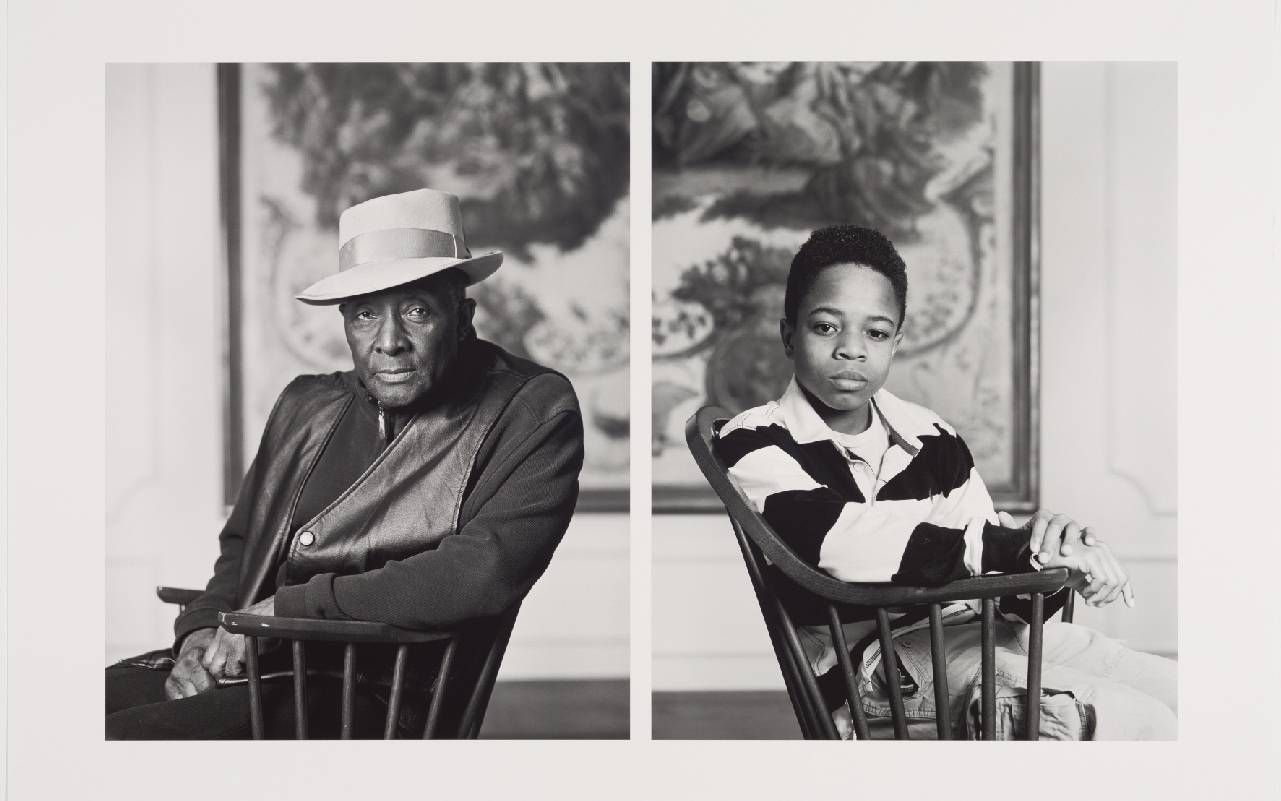 A sepia toned photograph of an older man and a young boy. Next Avenue