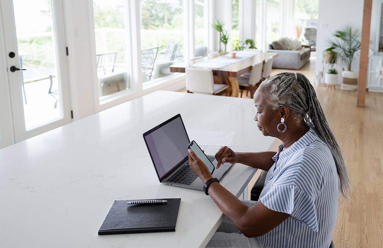 A retired woman updating her Linkedin profile at home. Next Avenue, how to make your linkedin profile stand out, retirement