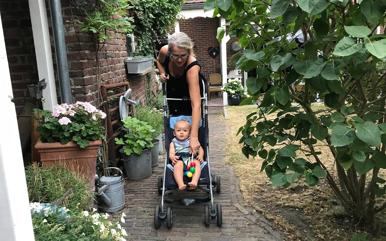 A grandmother taking a walk with her grandchild in a stroller. Next Avenue