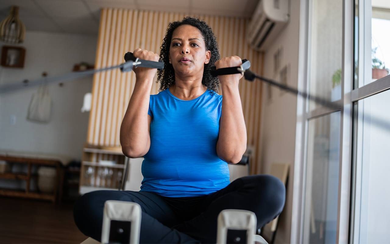 A woman doing core exercises in a pilates studio. Next Avenue, what does a physiatrist do for back pain