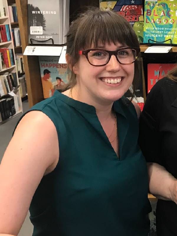 A woman smiling in a bookstore. Next Avenue, new books, gift ideas