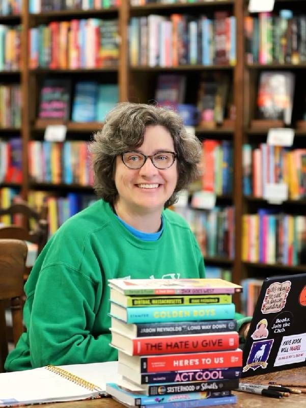 A woman smiling in a bookstore. Next Avenue, new books, gift ideas